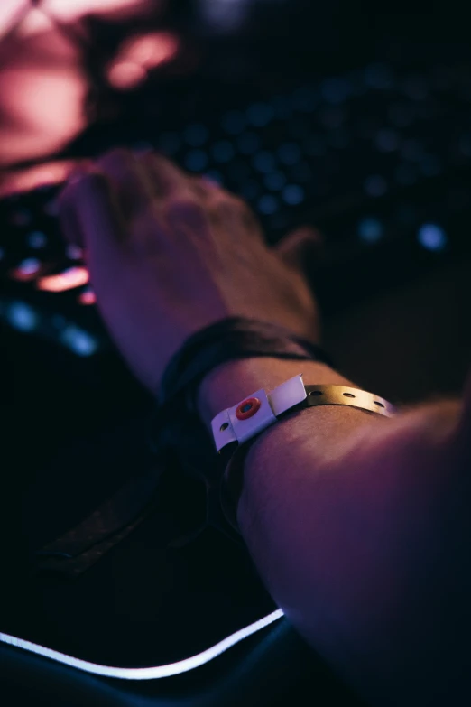 a close - up view of a man's wrist and keyboard