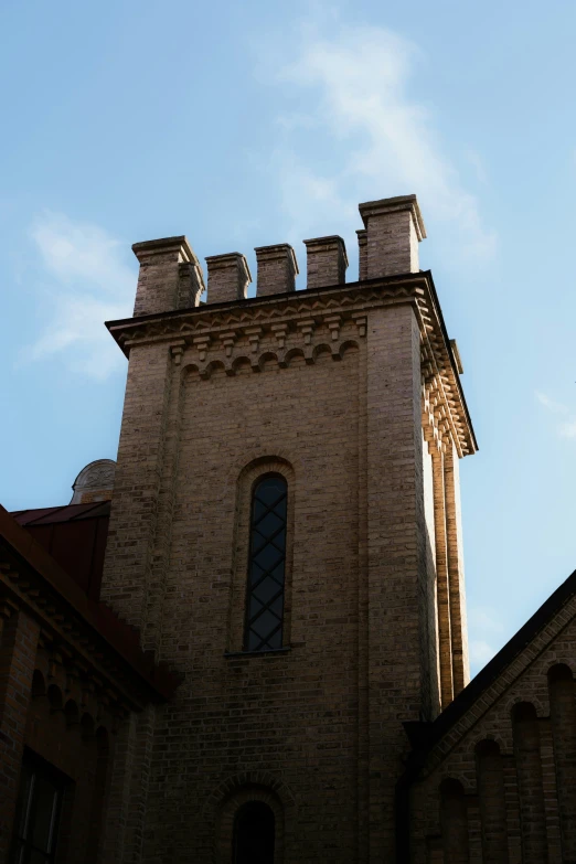 an old stone building with two arched windows