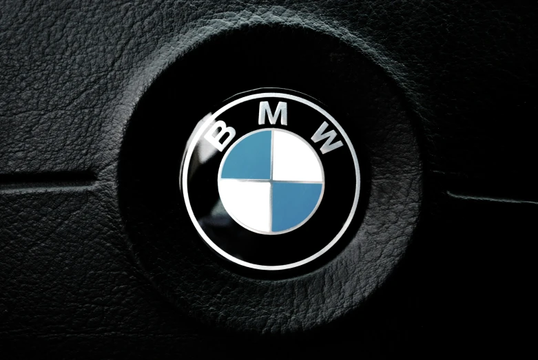 bmw emblem in the middle of a black leather car seat