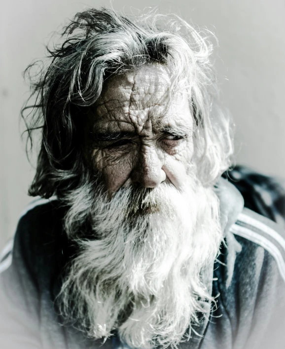 a man wearing an adidas shirt with long white hair