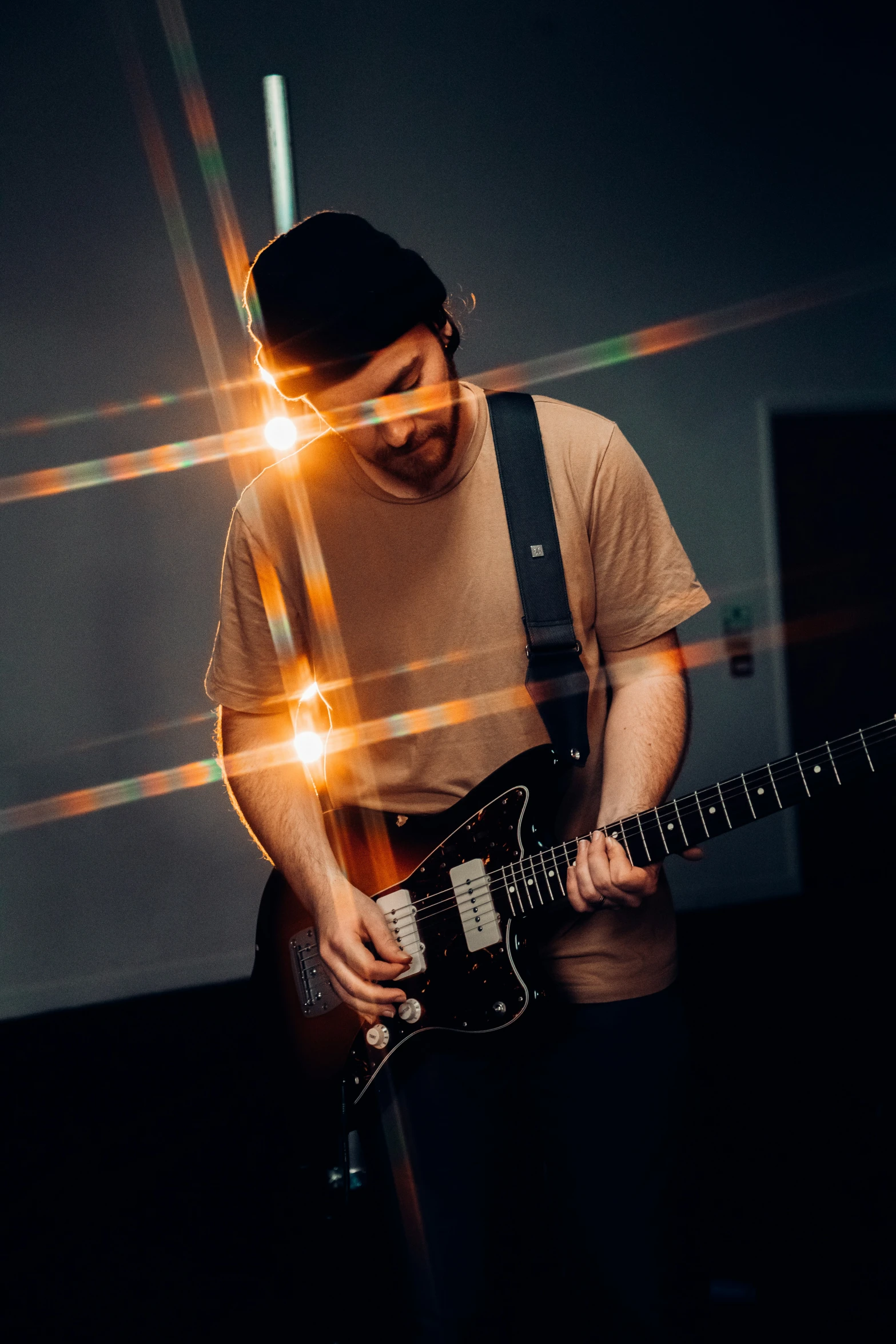 a man playing a guitar in a room