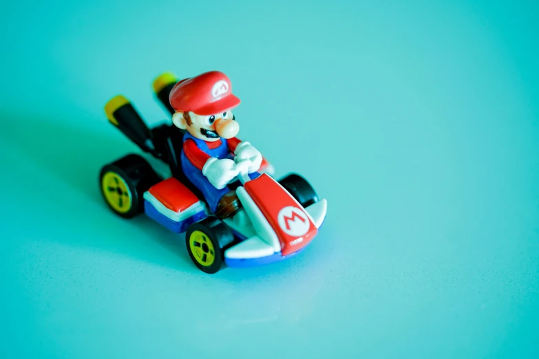a nintendo figure is riding a toy car