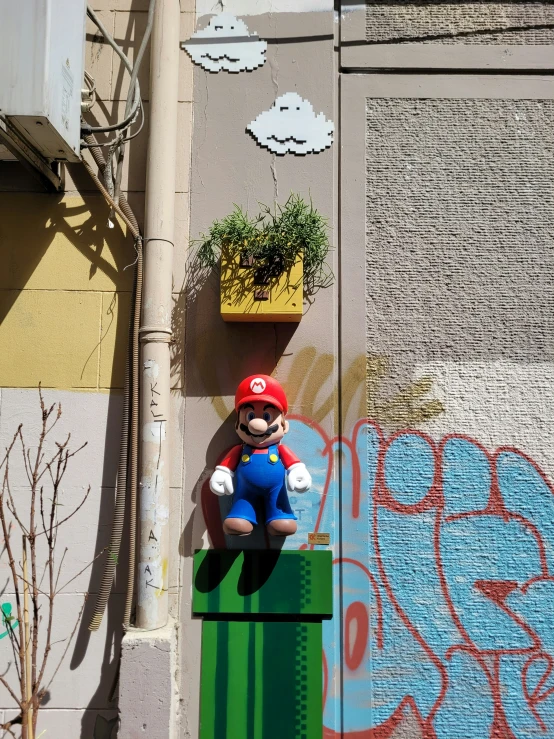 a mario mushroom sculpture in front of a graffitto