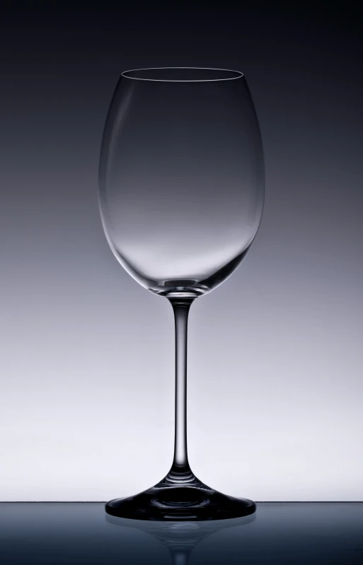 a large glass sitting on a table with a dark background