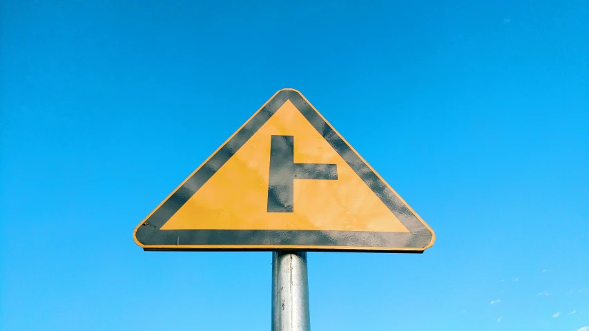 a traffic sign is shown against a blue sky