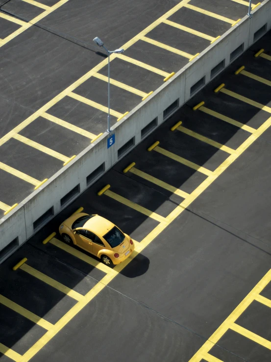 a yellow car sitting in a parking lot