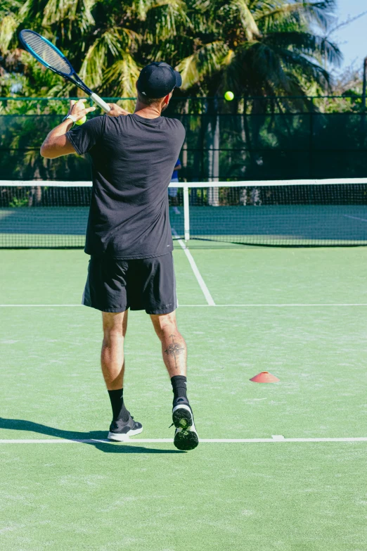 the man is ready to swing his tennis racket