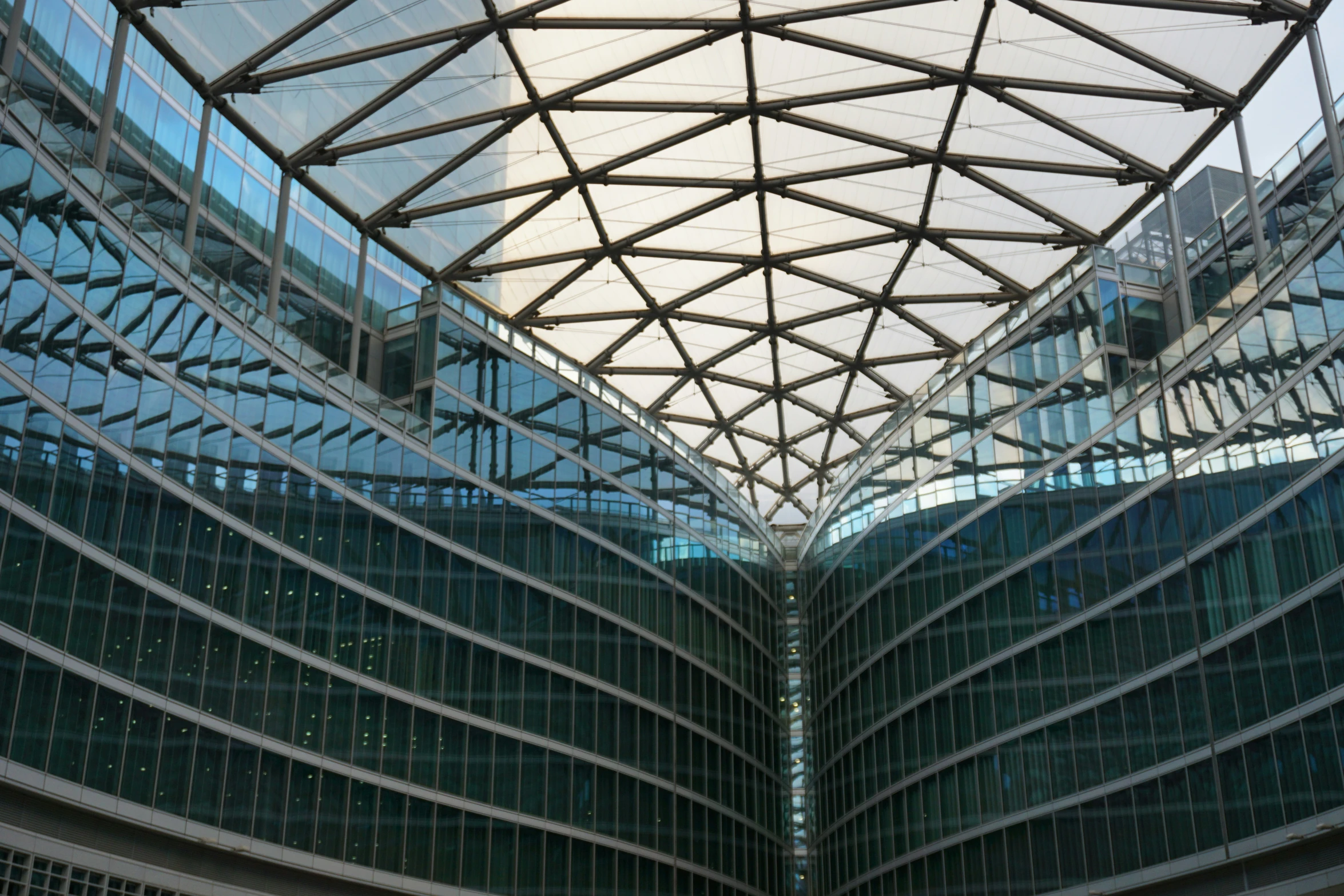 two buildings with lots of glass and metal covering them