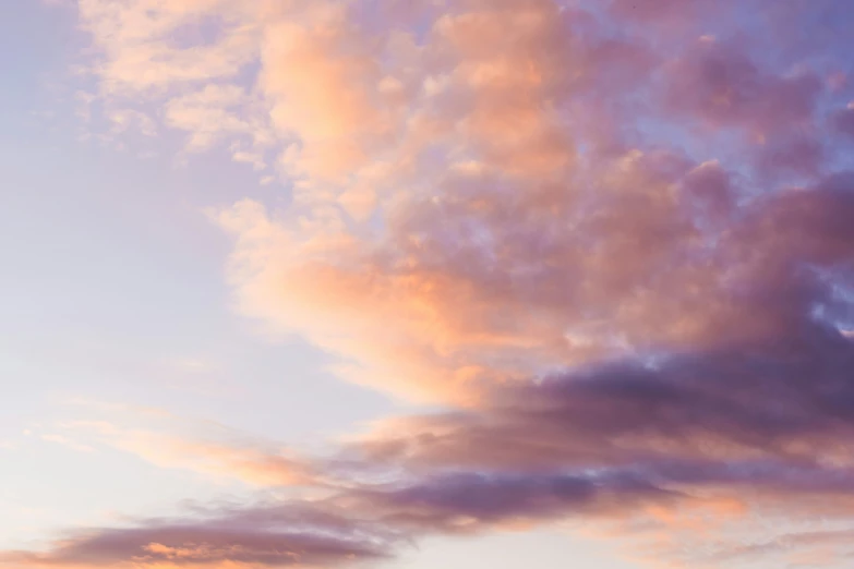 a plane is flying in the sky with clouds above it