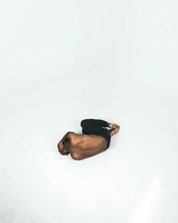 a man lying on the snow with his head in the air