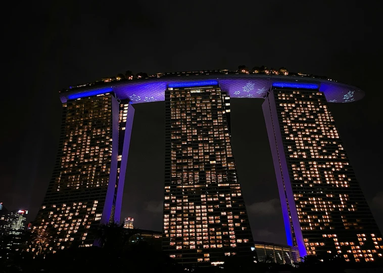 the top of the building is lit up in blue