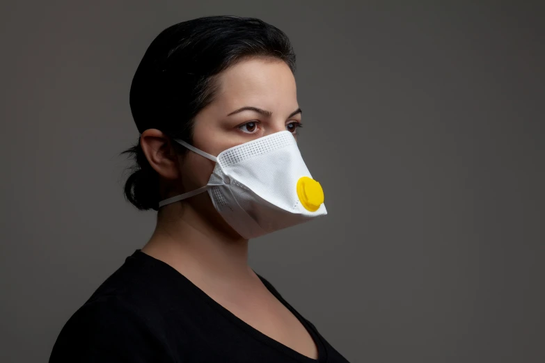 woman wearing a white face mask with yellow circles