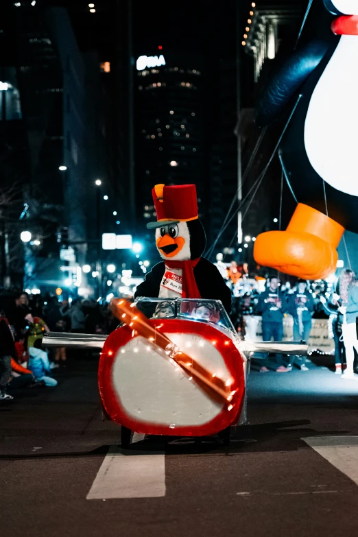 a penguin marching through the street at night