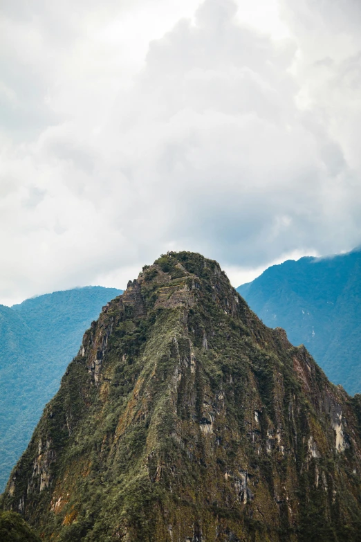 a large mountain sits at the base of some mountains