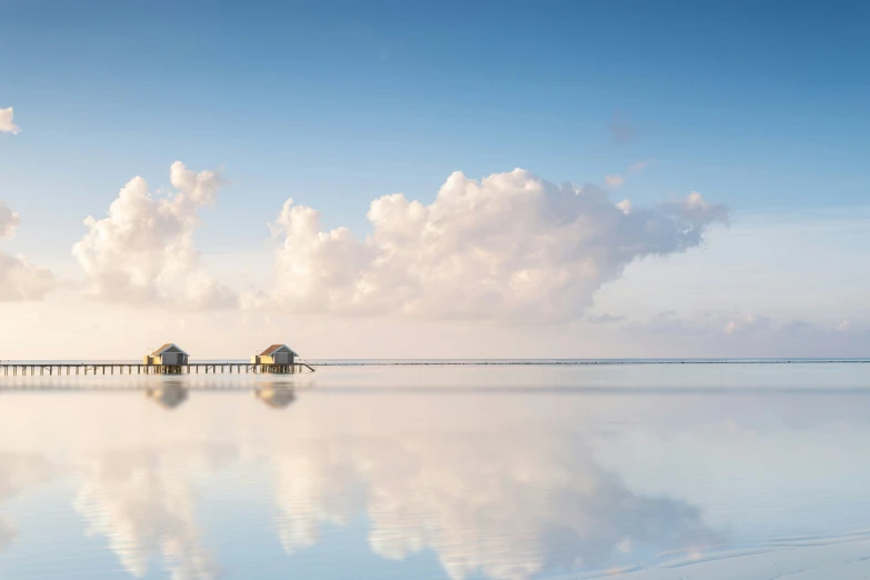 there are many small huts on the edge of the water