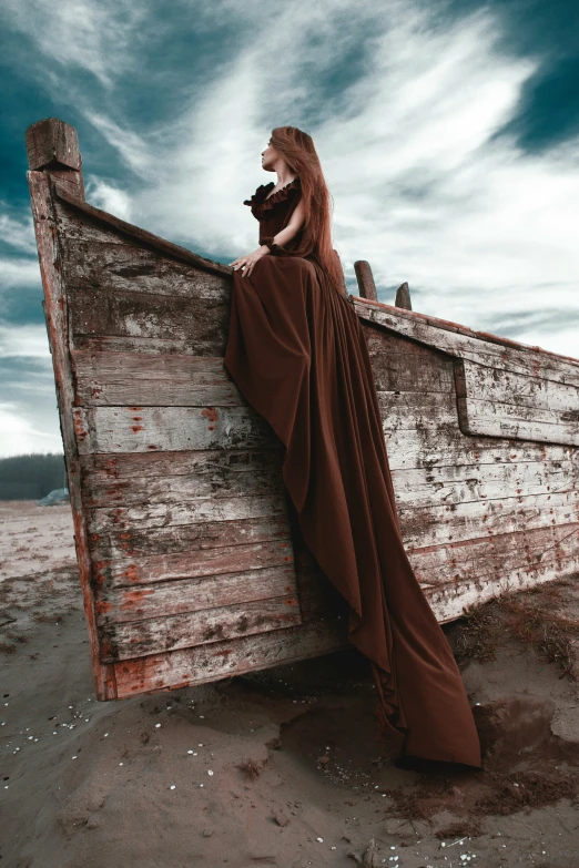 a woman with long hair sits on top of a boat