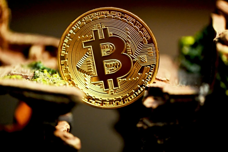 bitcoin on display near model figures, fake vegetables and trees