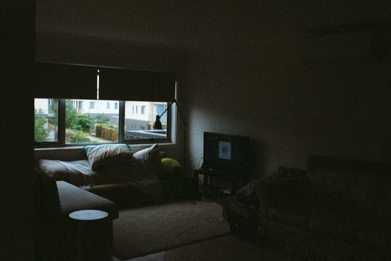 a living room with couches and a tv in it