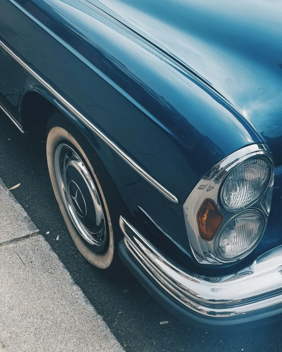 an old classic car parked on a street