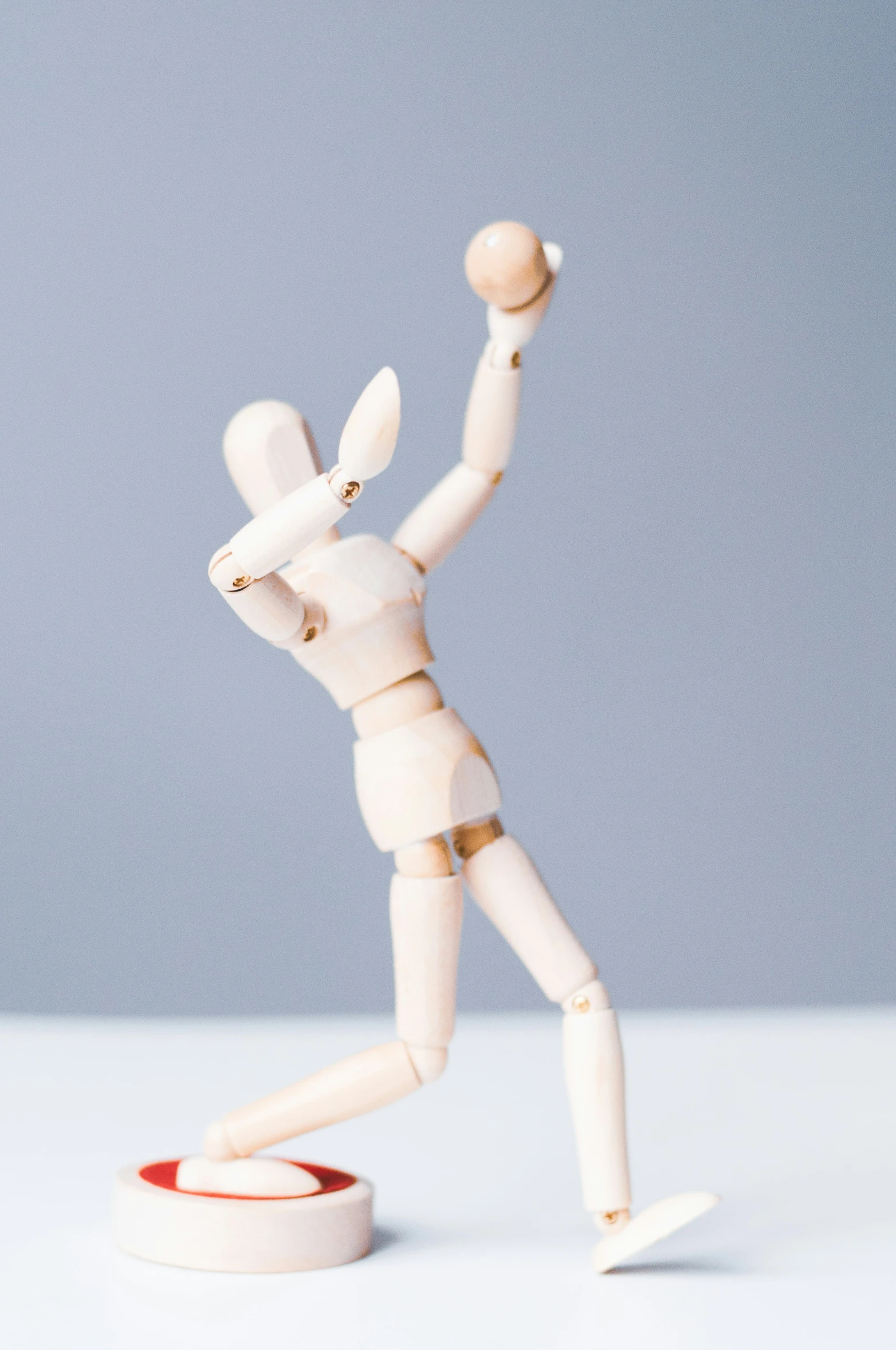 a figurine of a baseball player with a base