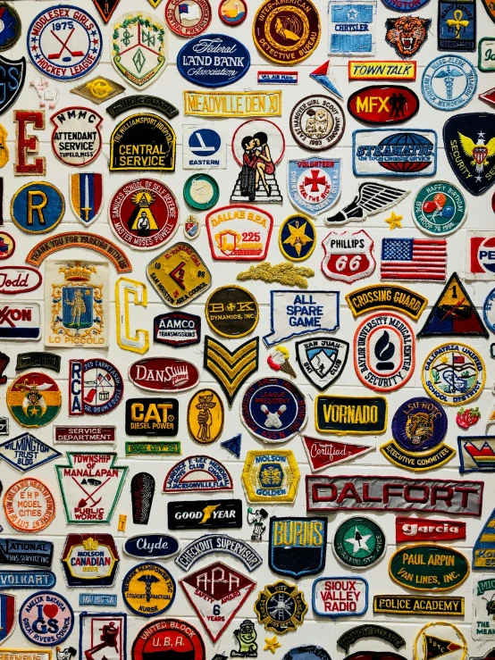 a wall covered with patches, such as us and national insignia