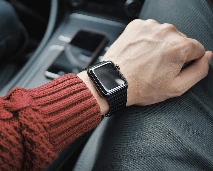 a person's arm on the console of their car