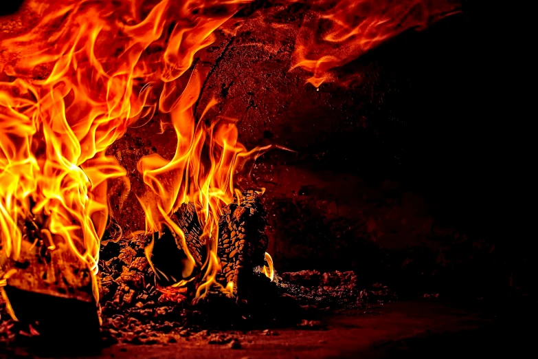 a fire is glowing against a dark background