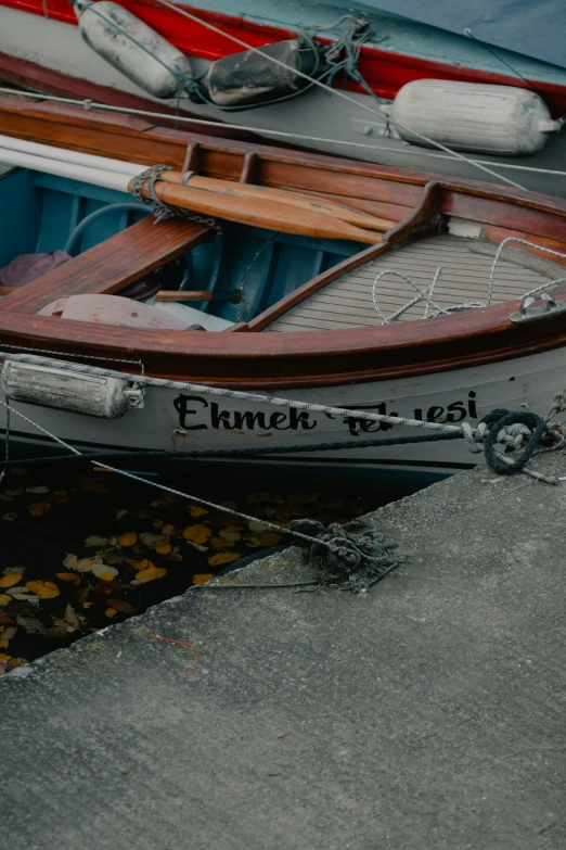 a close up of an empty row boat docked