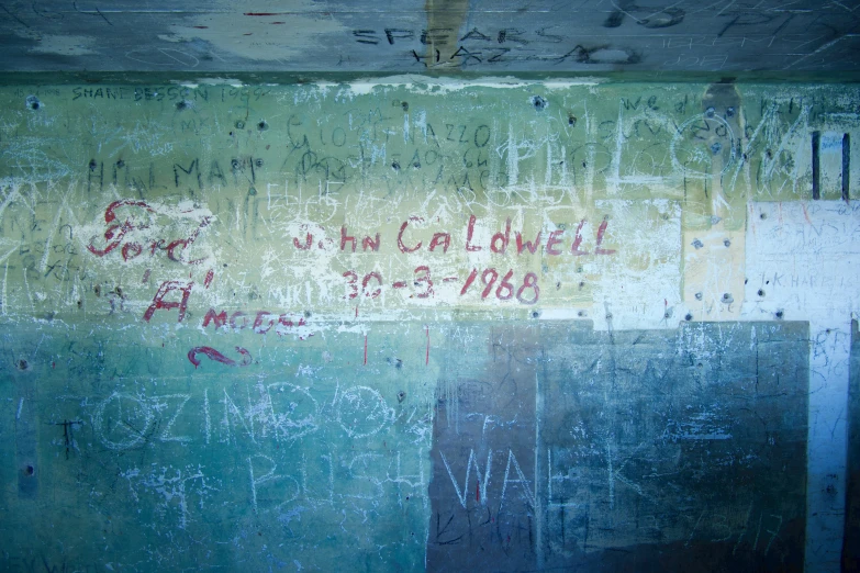 a blue and yellow painted wall with some writing