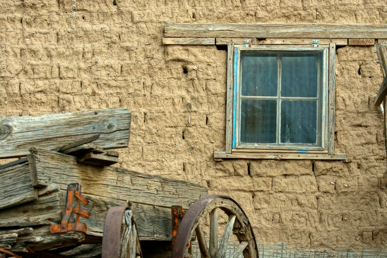 the old barn window has some blue glass on it