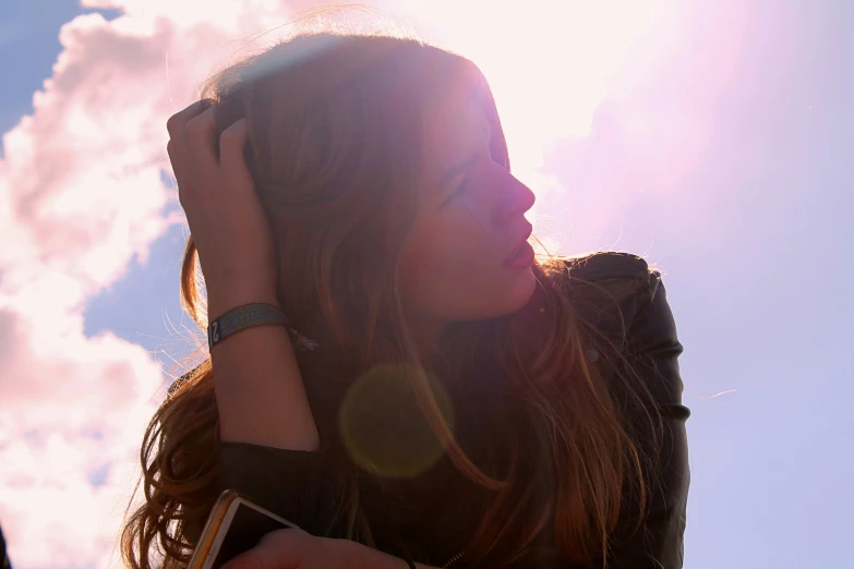 a woman that is holding her hands to her head