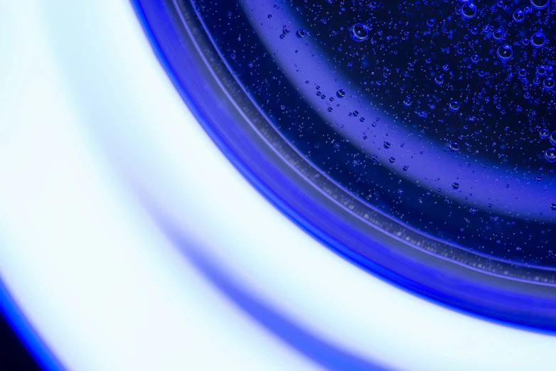 a dark blue plate with bubbles around it