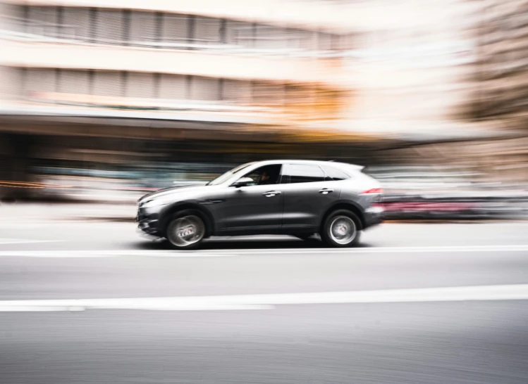 black car speeding through the city in an intersection