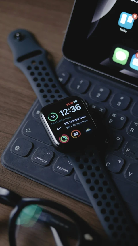 an apple watch and ipod are on a tablet