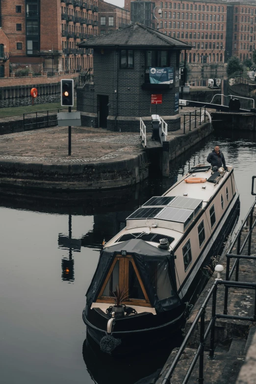 a boat floating in a body of water near large buildings