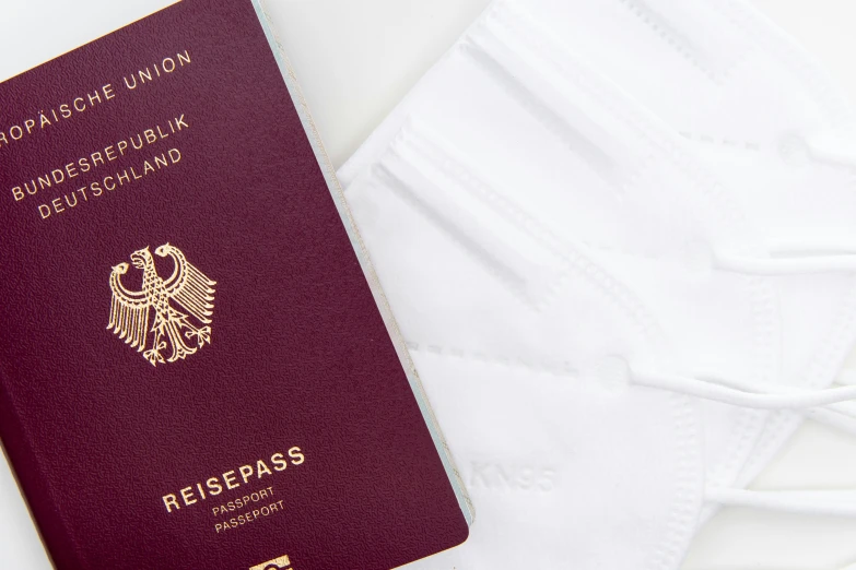 a united kingdom passport and white face mask