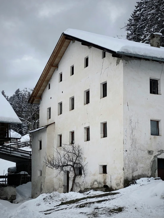 an old building is pictured in the snow