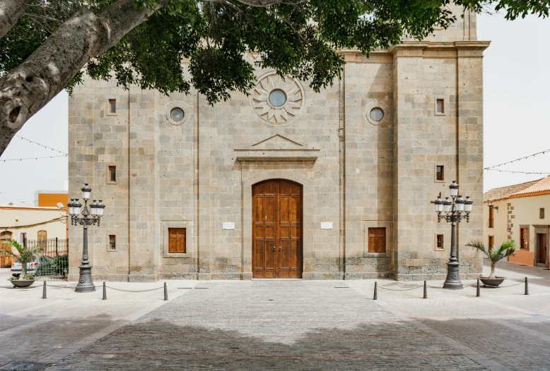 a large stone building with a tree in front of it