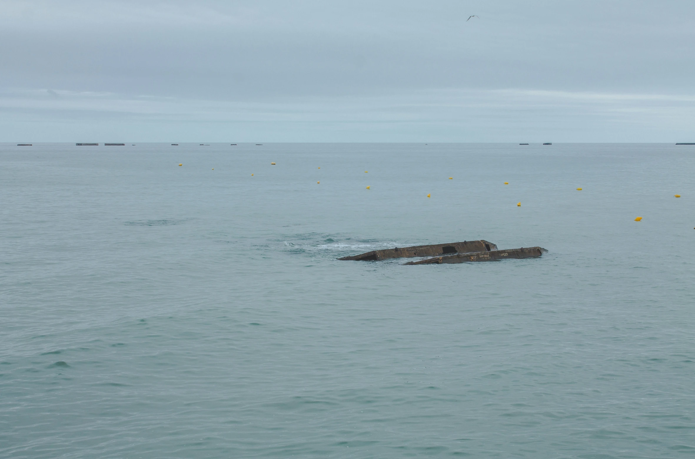 some boats on a body of water by an abandoned ship