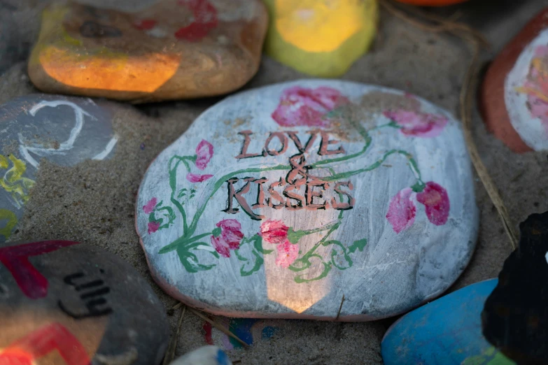 there are many rocks that say love and kisses