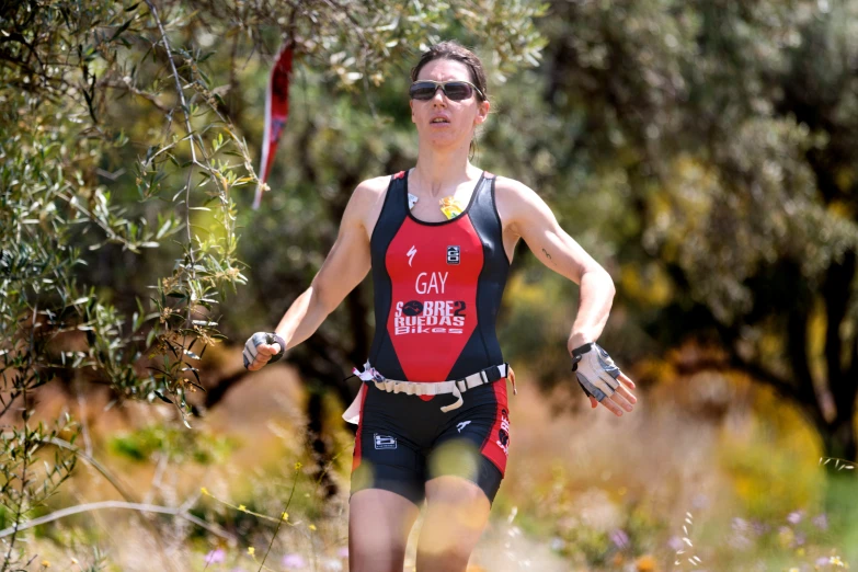 a man running a trail on a sunny day