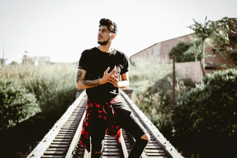 a man with tattoos on his body poses for the camera