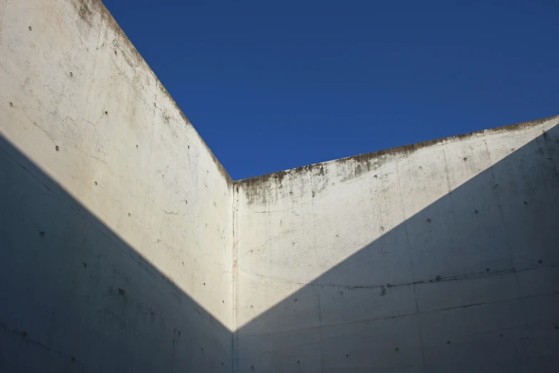 a bird is sitting on top of a concrete structure