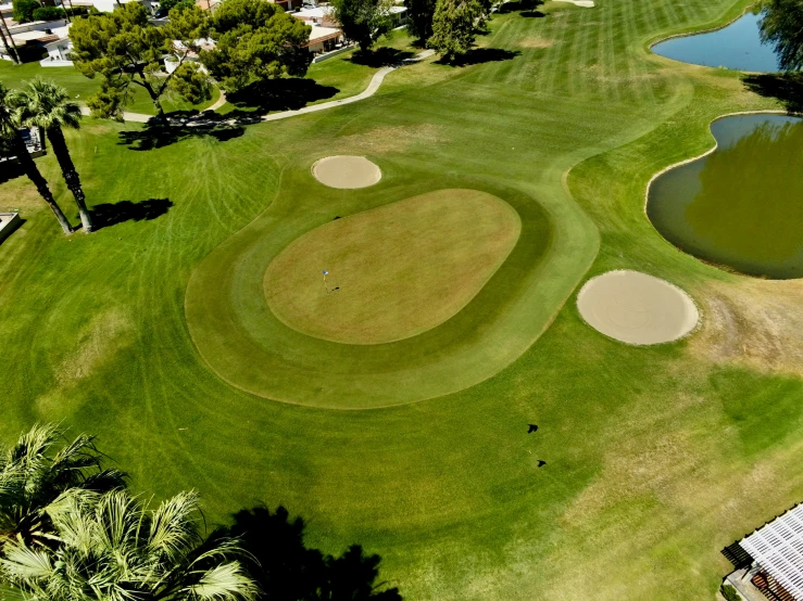 a golf course with holes and water next to it