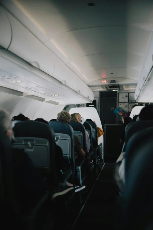 passengers sitting in an airplane with large windows