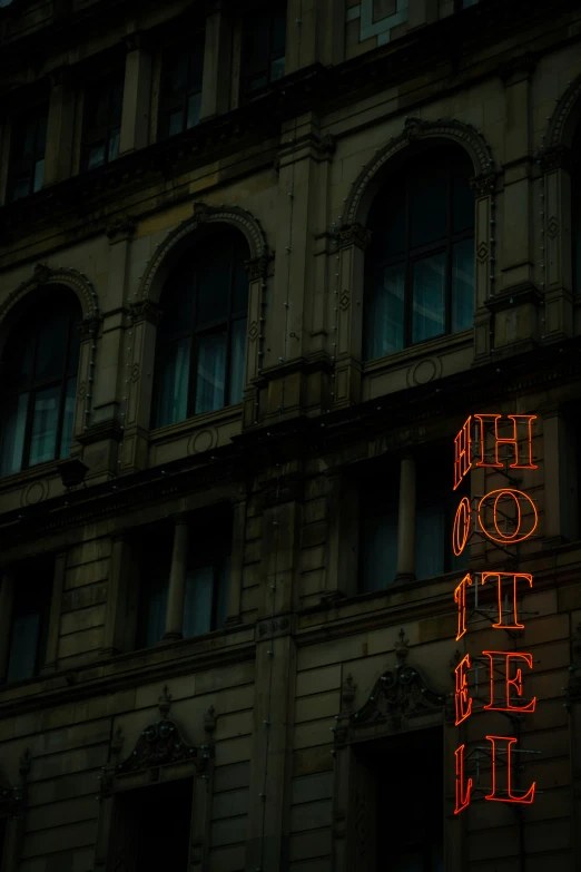 a large building with a neon sign that says el suite