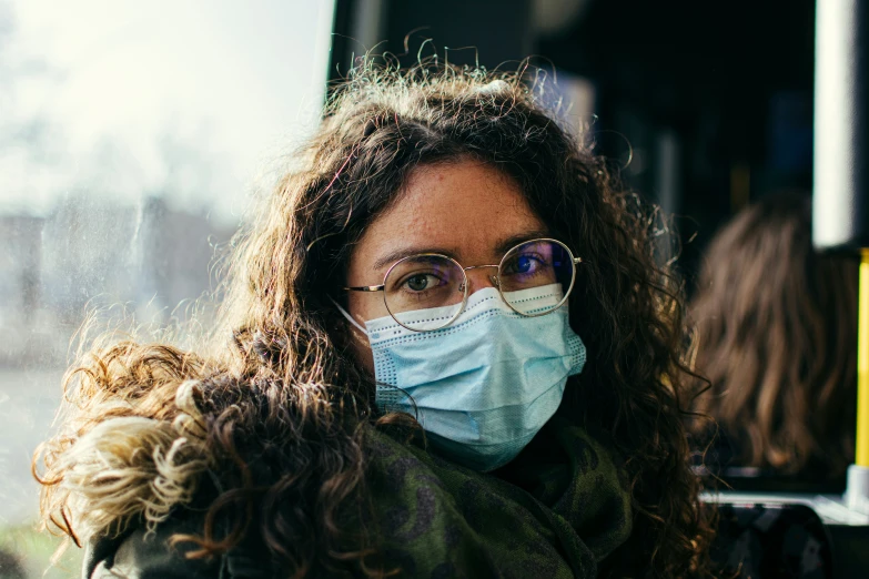 woman wearing a surgical face mask as protection from the corona