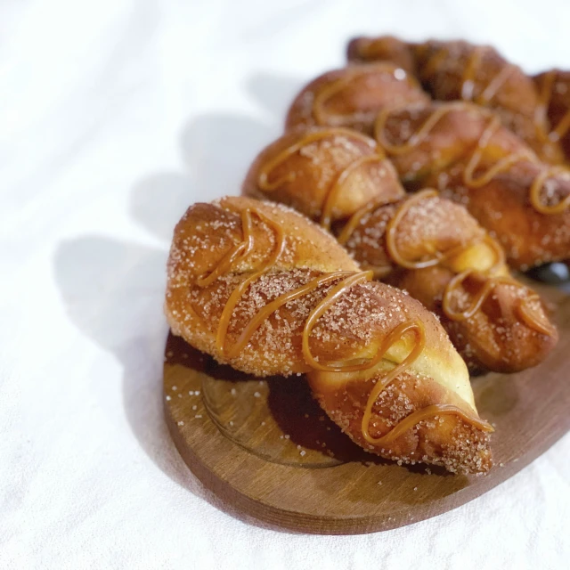 croissants covered in powdered sugar sitting on a plate