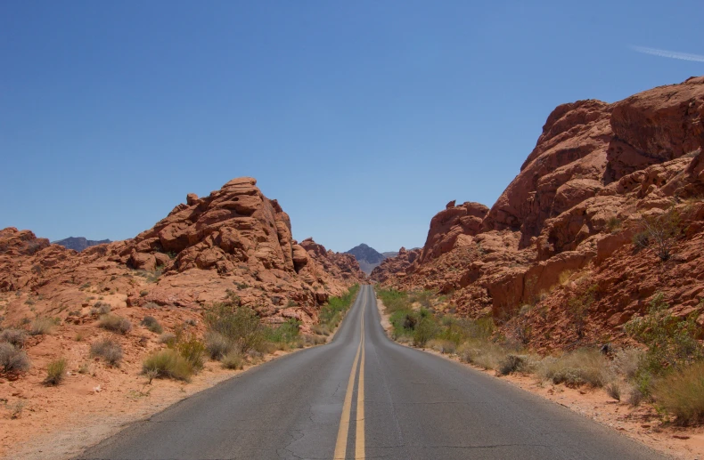 a road that leads to two very large mountains