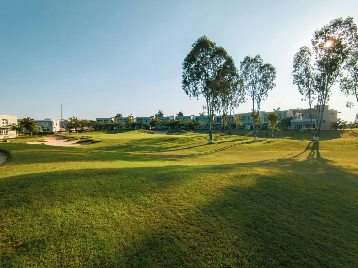 an image of a grass golf course and some houses